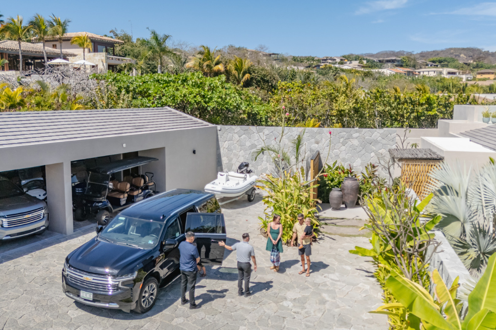 Luxury SUV airport transfer and 6-seater golf cart arranged by the VEHM concierge team for a seamless arrival at a Punta Mita private villa.